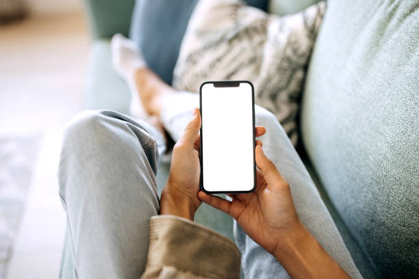 Unrecognisable woman holding smart phone with white screen Unrecognisable woman holding smart phone with white screen hold stock pictures, royalty-free photos & images