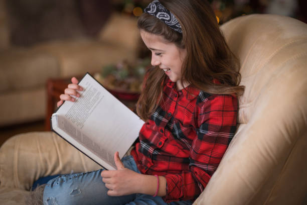 Girl laughing when reading a book