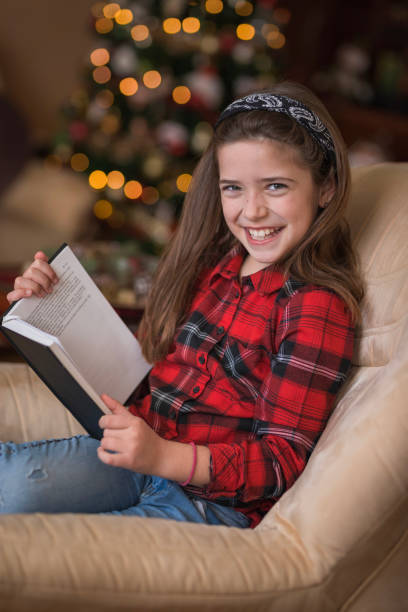 istock Girl holding a book and laughing 1423315038