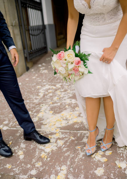 istock Crop newlyweds standing on path with flower petals 1423317287