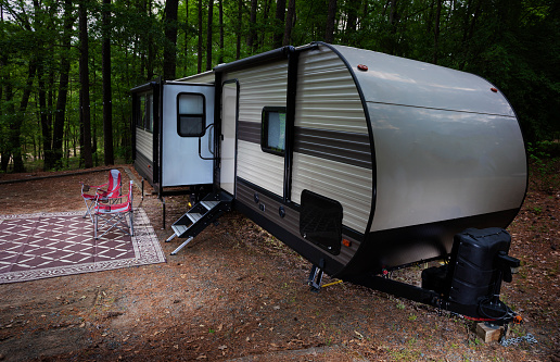 Travel trailer campsite at Jordan Lake in North Carolina with two empty chairs