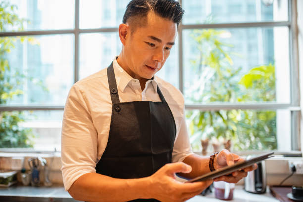 istock Working Portrait of Coffee Bar Owner Using Digital Tablet 1423319181