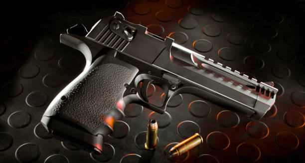 istock Semi-automatic pistol with ammo on a black rubber mat 1423319967