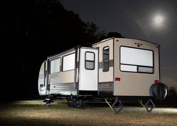 istock Camping trailer with slide out and moon above 1423321144