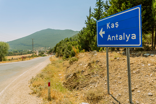 A sign on the highway showing the Antalya Kas road