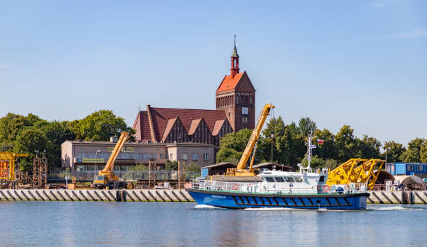 Gdansk, Poland - August 14, 2022: A picture of a vessel in front of the Maritime Church in Gdansk.