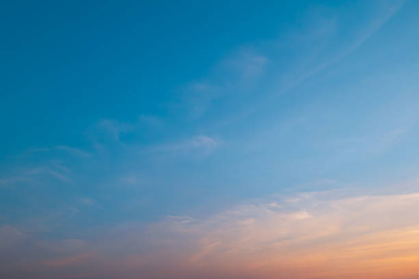 istock Bright orange sunset sky background with gentle colorful clouds, soft focus 1423324610