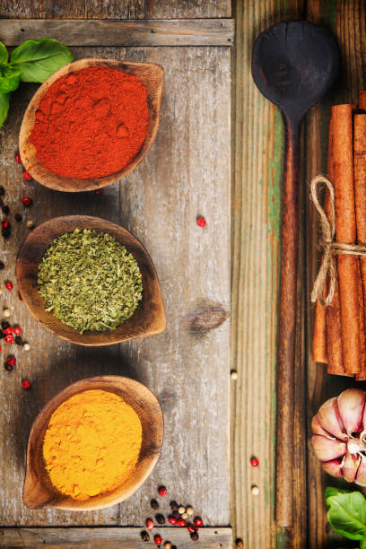 istock Cooking background with herbs, spices and rustic kitchen utensils, top view 1423325394