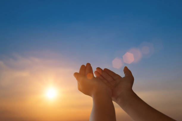 istock Child open empty hands with palms up for hope on sunset background. Freedom spirituality concept. 1423327136
