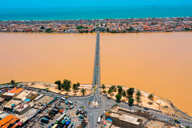 Faidherbe Bridge at Saint-Louis Saint-Louis is a city located on the northwest coast of Senegal. It is known for its colonial architecture. The old city is located on the island N'Dar of the Senegal River. The island is connected to the mainland by the Faidherbe Bridge of 1865, designed by Gustave Eiffel. Faidherbe Square has well-preserved ancient monuments, including the Governor's Palace and the neoclassical cathedral. The CRDS museum is dedicated to traditional arts and crafts. sénégal stock pictures, royalty-free photos & images