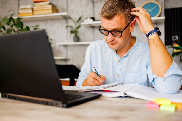 istock Man listening online teacher and underline text in book 1423330205