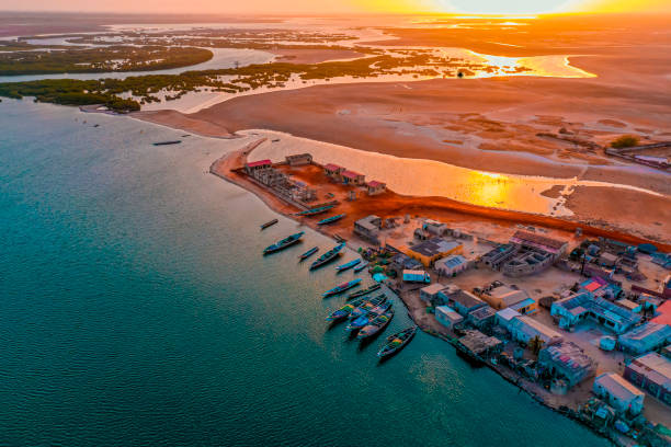 Sunset at Ndangane Campment (SENEGAL) Ndangane-camp: tourist village consisting mainly of a straight shopping street perpendicular to the beach. More western houses, gardens, fences.

Both villages have access to the sea. A cove separates them at high tide. sénégal stock pictures, royalty-free photos & images