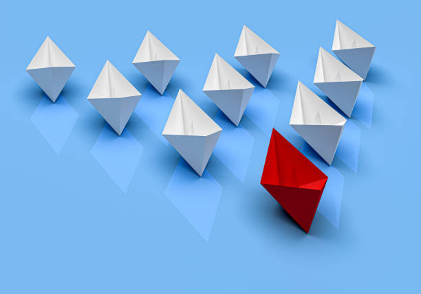 istock Leadership and business concept. One red leader ship leads other white ships forward 1423334993