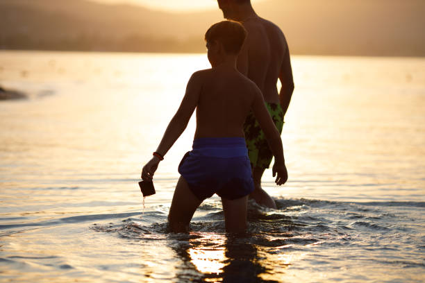 istock Father and son playing on the beach 1423335368
