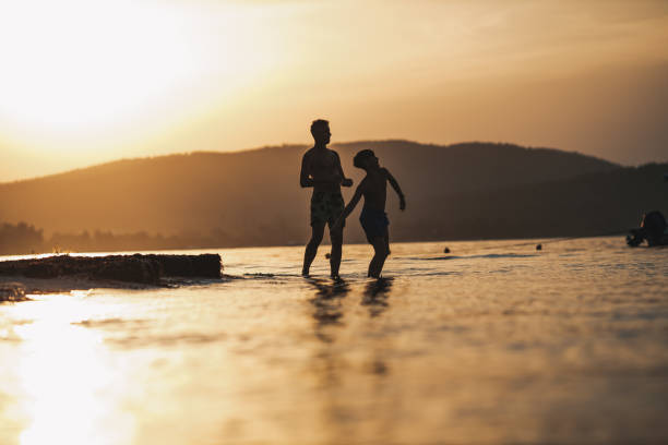istock Father and son playing on the beach 1423335409