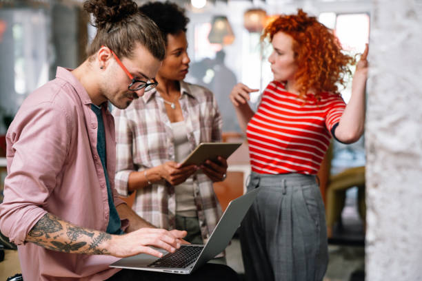 istock Smiling diverse colleagues gather in boardroom brainstorm discuss financial statistics together 1423335713