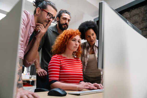 istock Group of young happy creative team, multicultural coworkers working in office together 1423335759