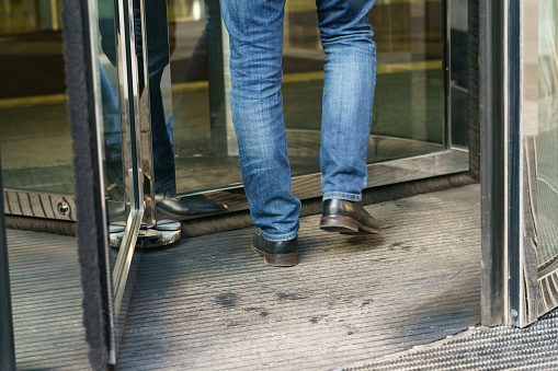 Photography of revolving office door entrance of Moscow International Business Center (MIBC). Businessman coming. Business concepts and modern lifestyle. Close up photography. Back, rear view