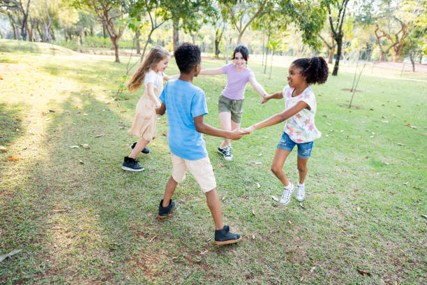 istock Small group of children playing in the public park 1423340433