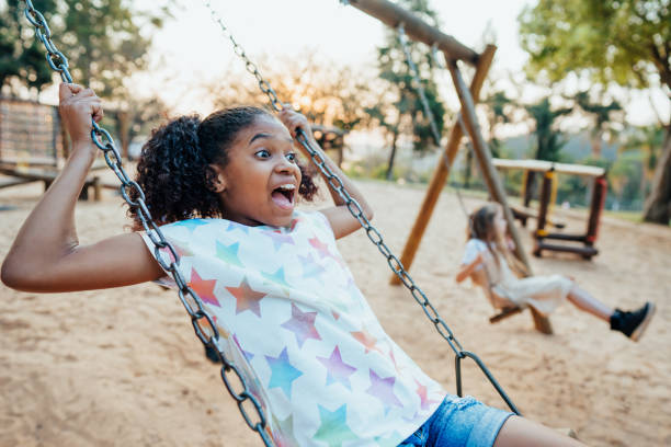 istock Children playing on the playground swinging 1423341047