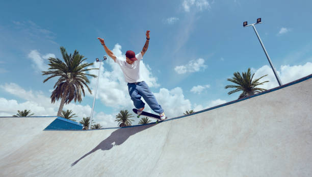 istock Skateboarder doing a trick in a skate park 1423341874