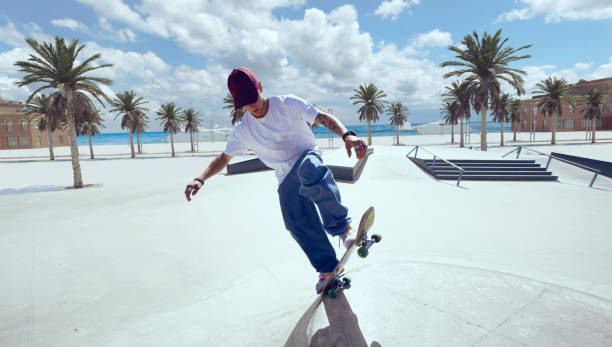 istock Skateboarder doing a trick in a skate park 1423341920