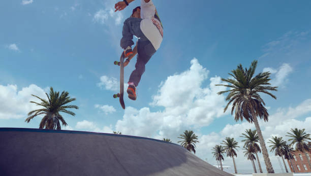 istock Skateboarder doing a trick in a skate park 1423341926
