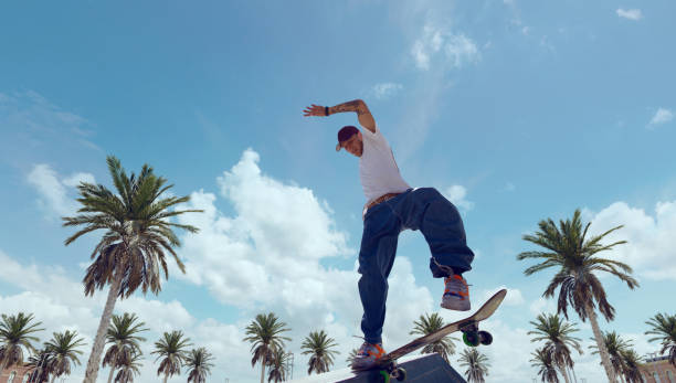 istock Skateboarder doing a trick in a skate park 1423341938