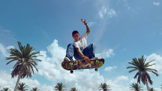 Skateboarder doing a trick in a skate park Skateboarder Ollie stock pictures, royalty-free photos & images