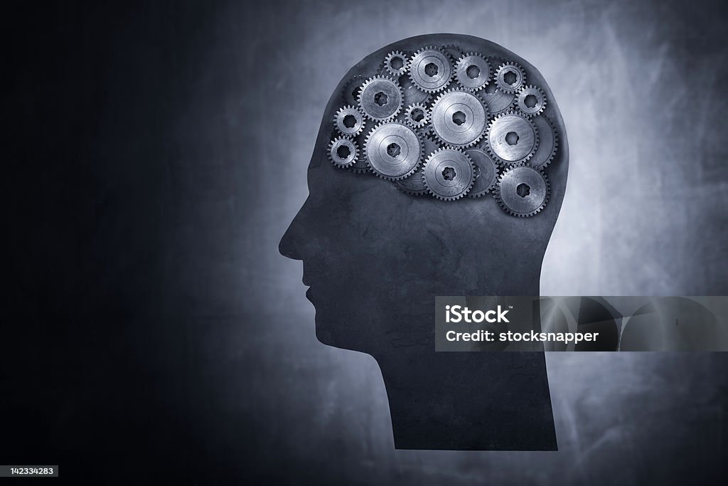 The gears in a guy's brain working Conceptual image of head filled with cog gears. Brainstorming Stock Photo