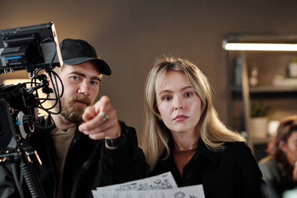 istock Confident videogrpaher explaining his assistant what to pay attention to 1423343426