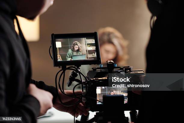 Closeup Of Steadicam Screens With Female Model Using Laptop By Table Stock Photo - Download Image Now