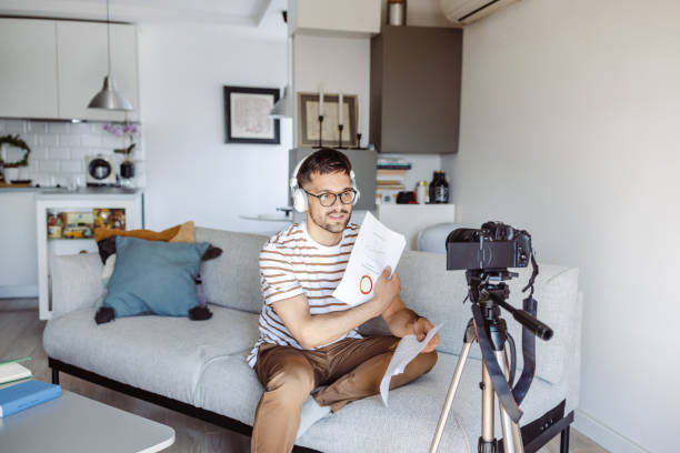 istock Young man recording a video at home 1423343683