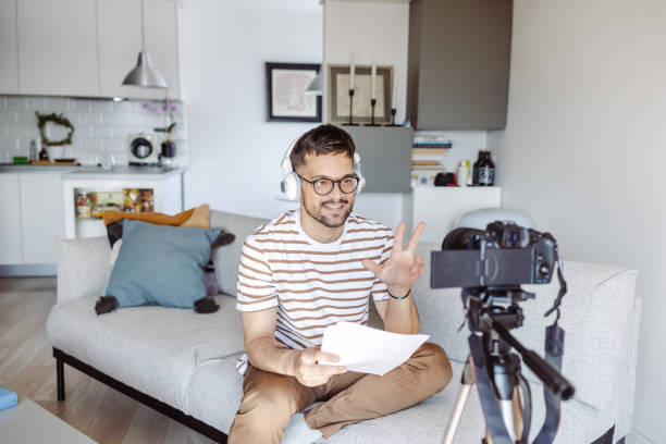 istock Young man recording a video at home 1423343723