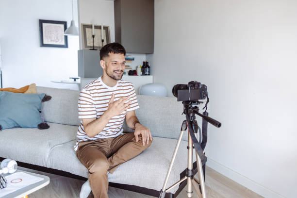 istock Young smiling man recording vlog and talking 1423343797