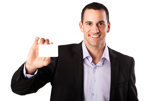 Portrait of smiling young businessman holding a business card.Isolation on white