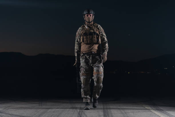 armeesoldaten in kampfuniformen mit sturmgewehr, plattenträger und kampfhelm auf eine gefährliche mission in einer regnerischen nacht. - real people caucasian one person black and white stock-fotos und bilder