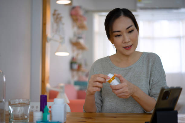 istock Woman is reading Prescription Medication Label. 1423344476