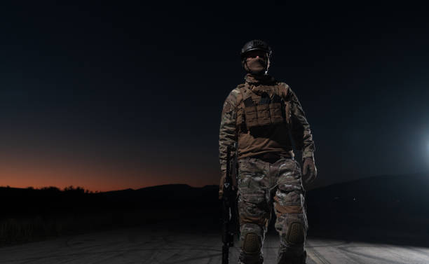 armeesoldaten in kampfuniformen mit sturmgewehr, plattenträger und kampfhelm auf eine gefährliche mission in einer regnerischen nacht. - real people caucasian one person black and white stock-fotos und bilder