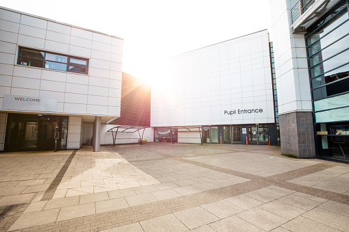 A wide shot of the entrance and building exterior of a secondary school in the North East of England.