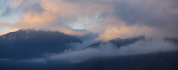 istock Dawn in the mountains, fog and clouds on the peaks, panoramic 1423347013
