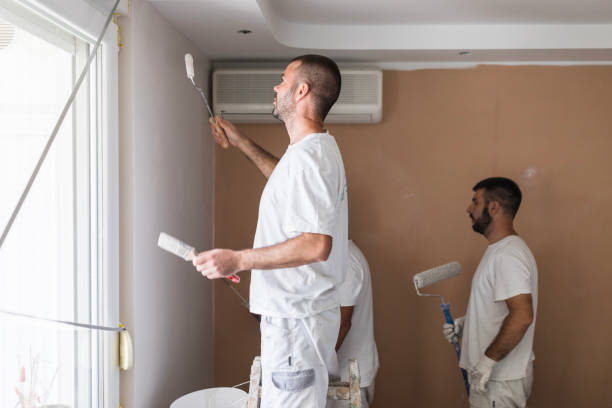 istock Men painting the room white 1423348002