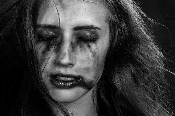 injured woman with smeared makeup, monochrome