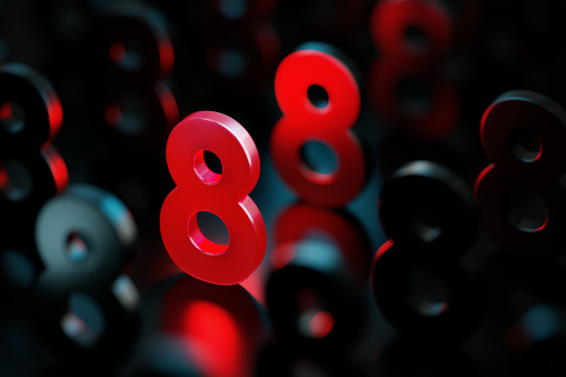 Red number eight glowing amid black numbers on black background. Horizontal composition with copy space. Standing out from the crowd concept.