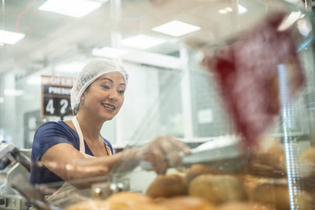 istock Employee getting some bread to customer in a bakery 1423348810