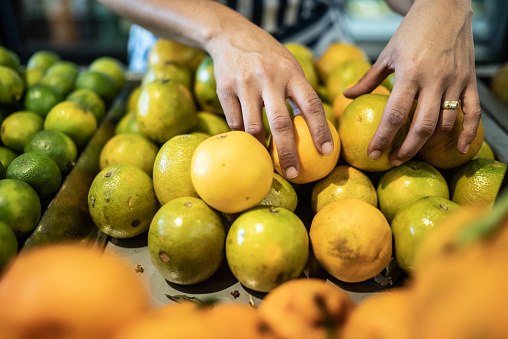 Female hands arranging fruits in a market