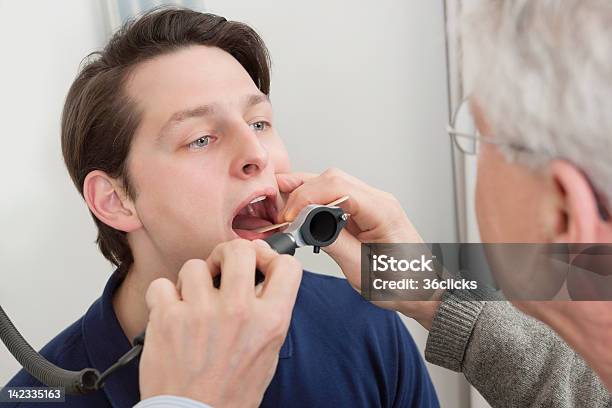 Throat Exam With Depressor Stock Photo - Download Image Now - Uvula, 20-29 Years, 50-59 Years