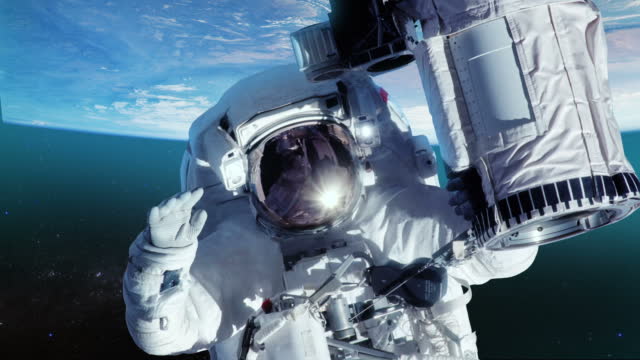 Astronaut in outer space against the planet earth. Close-up.