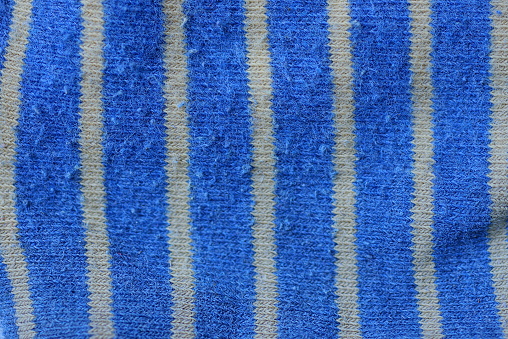 blue yellow striped fabric texture of a piece of wool on clothes