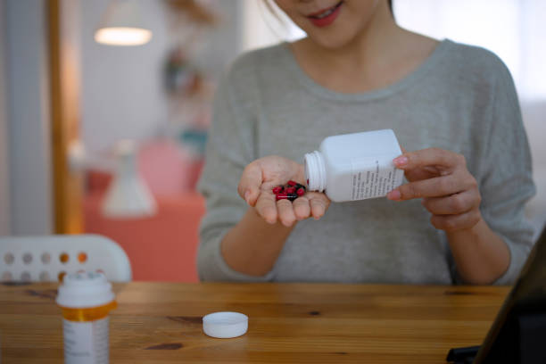 istock Woman is reading Prescription Medication Label. 1423353308